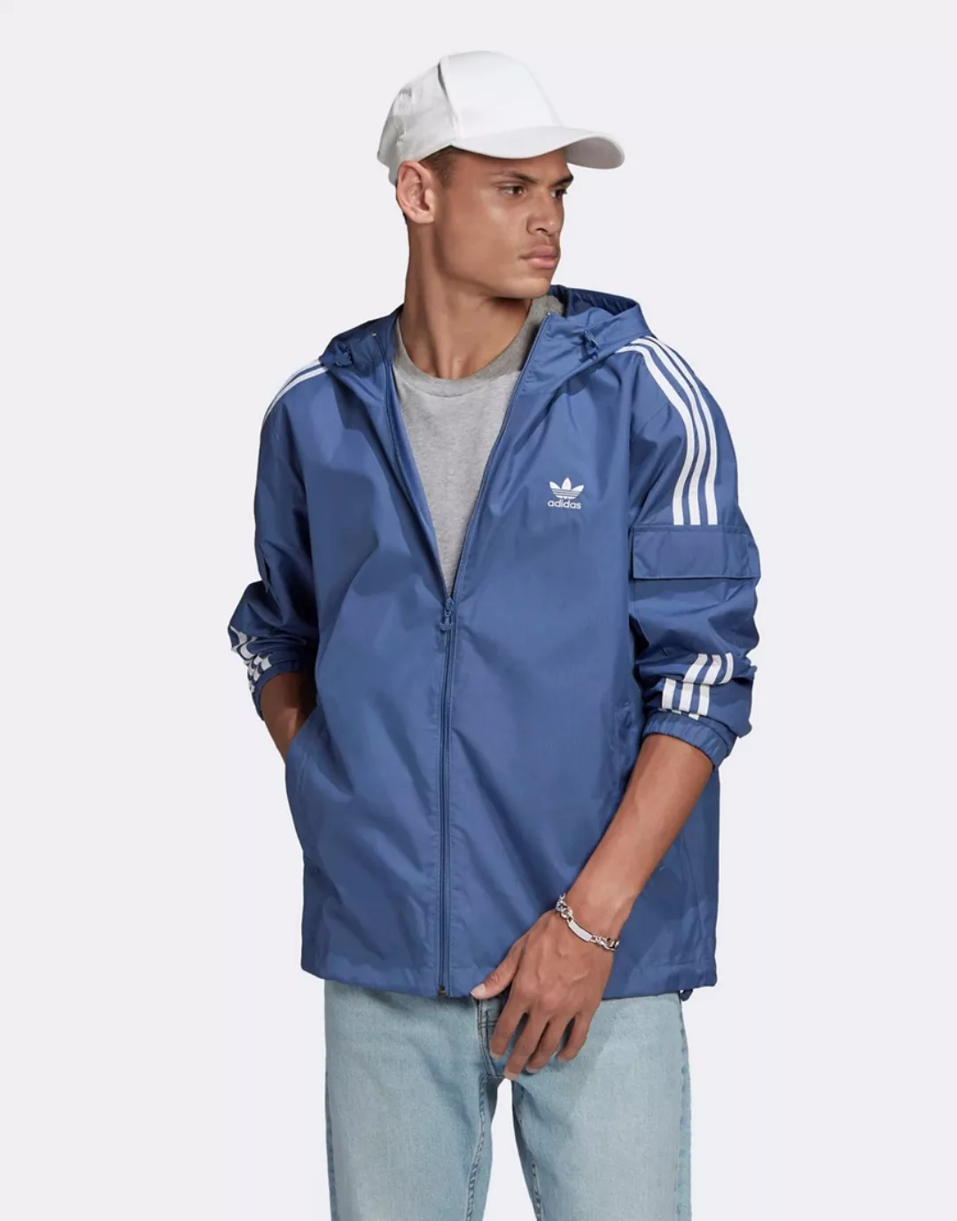 adidas Originals – adicolor – Blaue Windjacke mit drei Streifen günstig online kaufen
