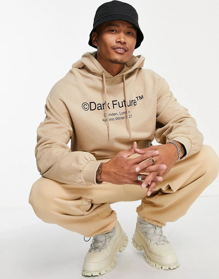 ASOS – Dark Future – Oversize-Kapuzenpullover in Beige mit Logoprints und B günstig online kaufen