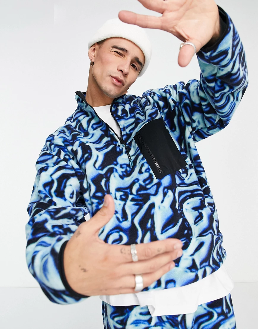 ASOS DESIGN – Gemustertes Oversize-Sweatshirt aus Fleece mit Halbreißversch günstig online kaufen