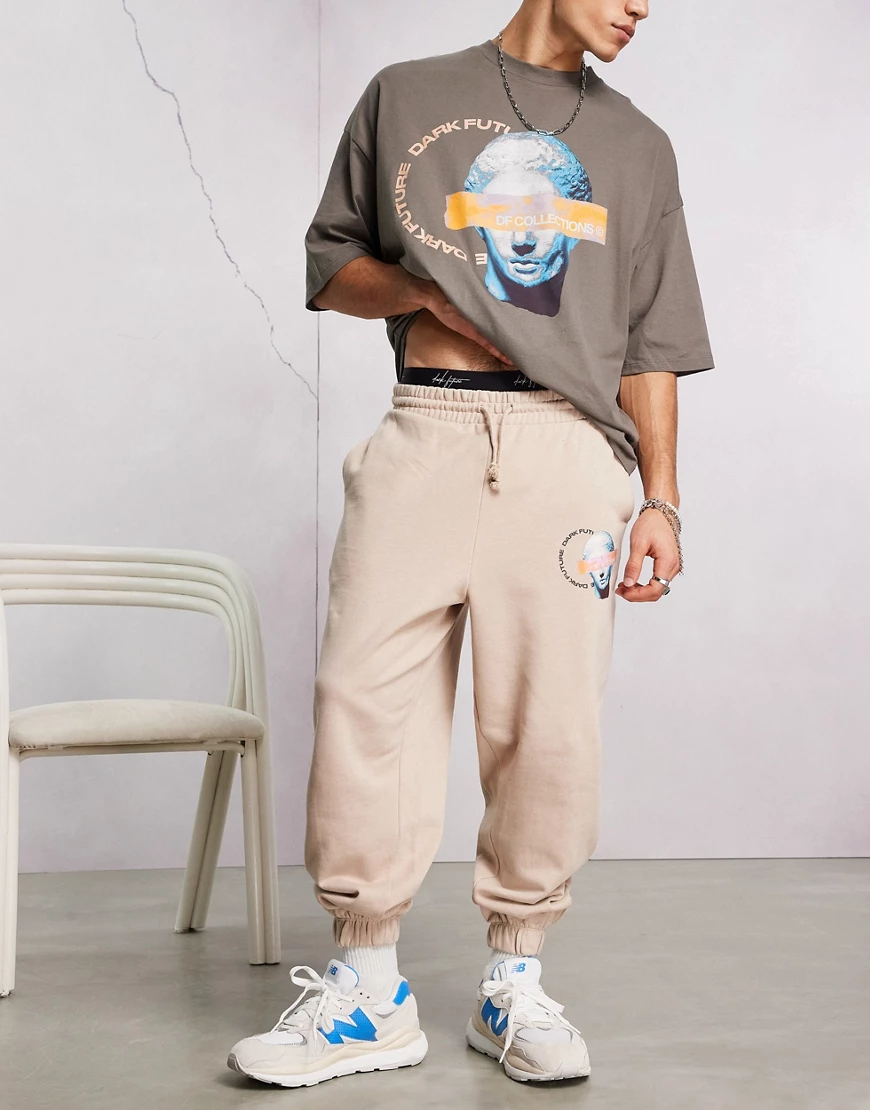 ASOS – Dark Future – Oversize-Jogginghose in Beige mit Grafikprint und Logo günstig online kaufen