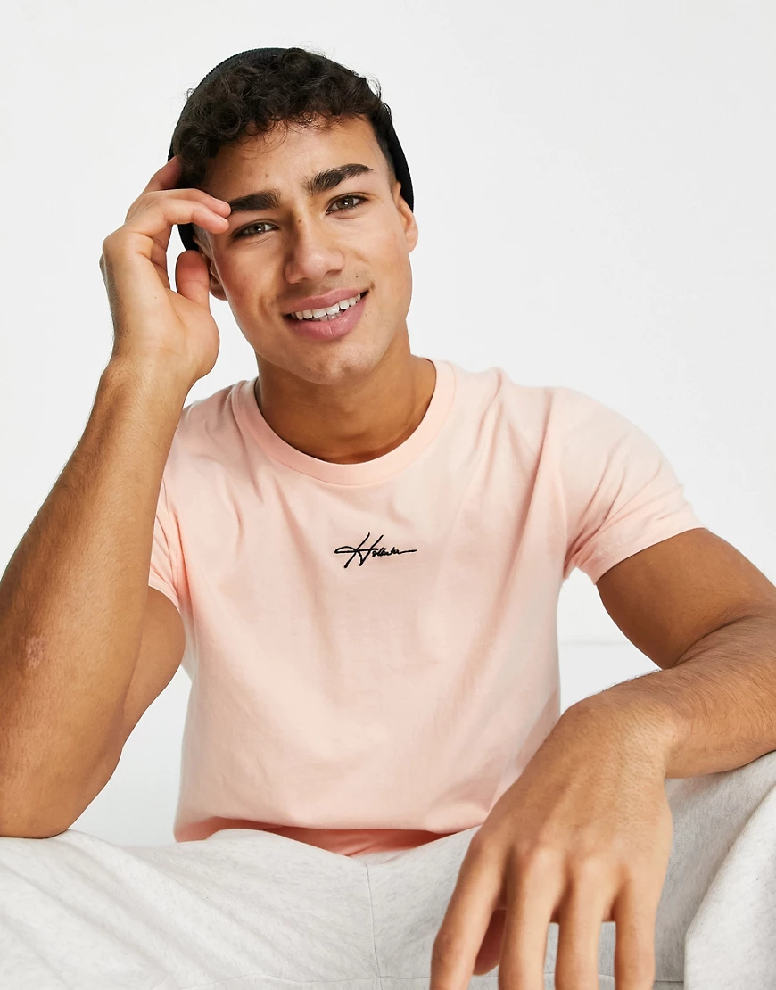 Hollister – T-Shirt in Pfirsichrosa mit mittigem Logo-Schriftzug günstig online kaufen