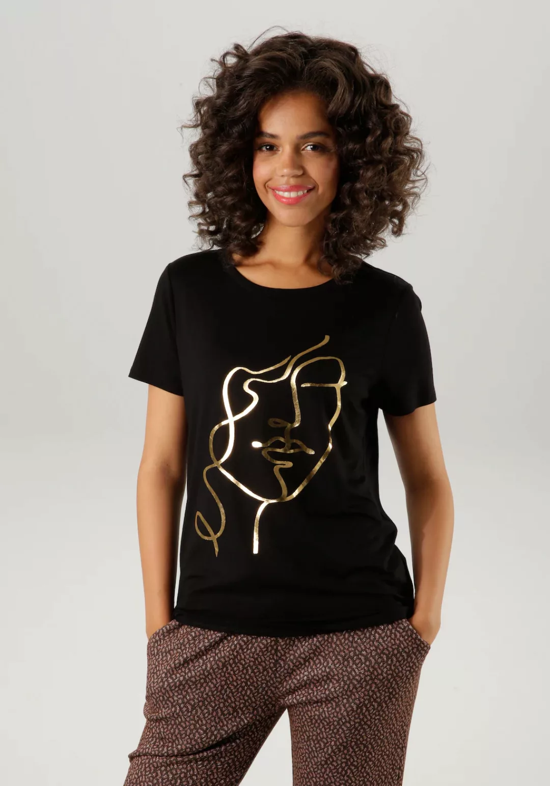 Aniston CASUAL T-Shirt, mit abstraktem Gesicht aus goldfarbenem Folienprint günstig online kaufen