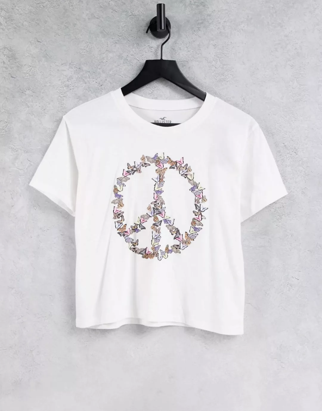 Hollister – Earth Day – T-Shirt mit Peace-Zeichen, Schnürung vorn und Schri günstig online kaufen